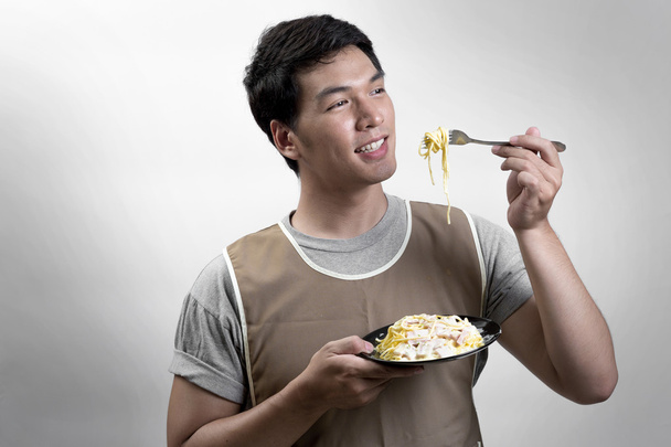 Asian man eatting spaghetti carbonara - Photo, Image
