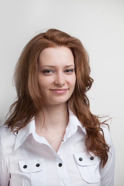 Smiling woman in white blouse, portrait - Foto, afbeelding