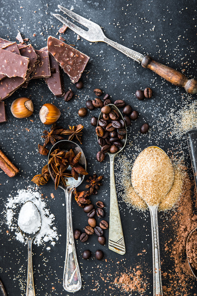 Sweet ingredients  and chocolate on a table - Fotó, kép