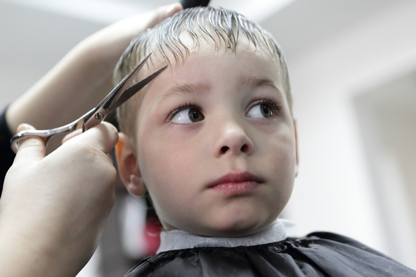 Serious kid having a haircut - Foto, afbeelding