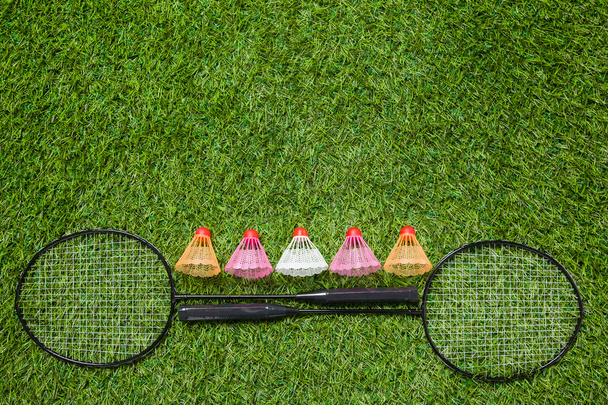 Two badminton rackets with color shuttlecocks - Фото, изображение