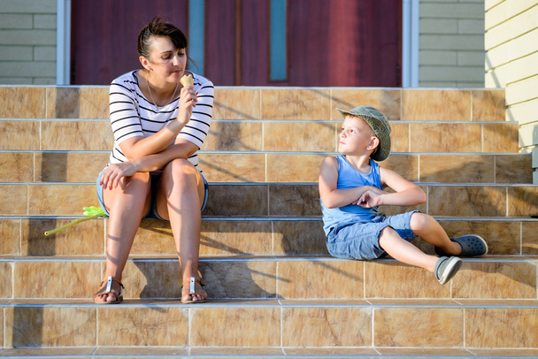 Boy Watching Mother Eat Ice Cream Cone on Steps - Photo, Image