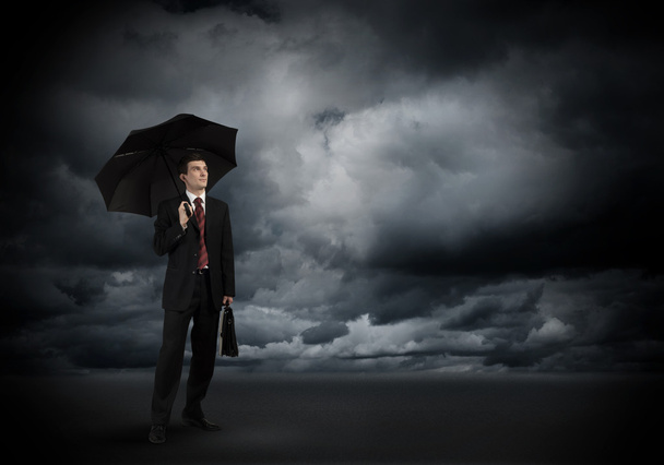 Young businessman with umbrella - Photo, image