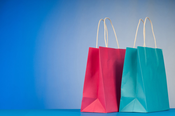 Shopping bags against gradient background - Foto, Imagen