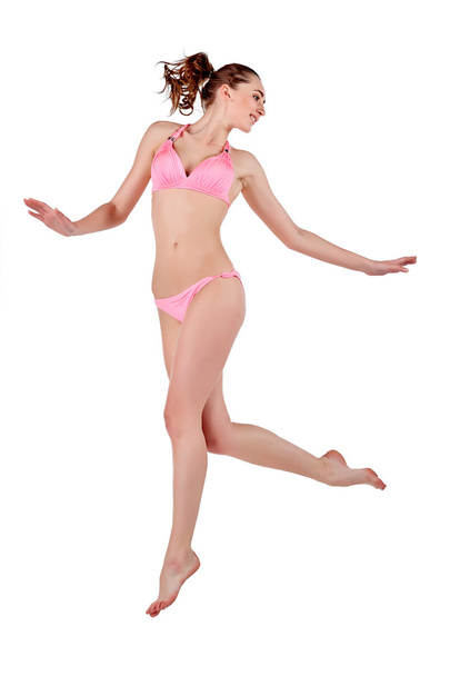 Beautiful young woman in pink swimwear - 写真・画像