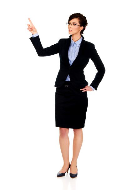 Businesswoman pointing up. - Foto, afbeelding