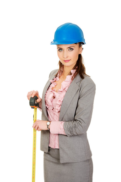 Engineer woman holding tape measure in hand. - 写真・画像