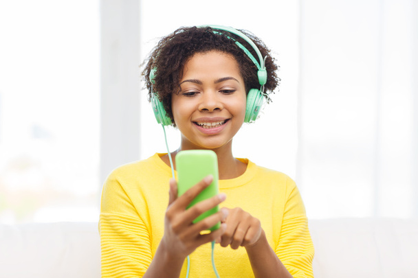 happy african woman with smartphone and headphones - Photo, image