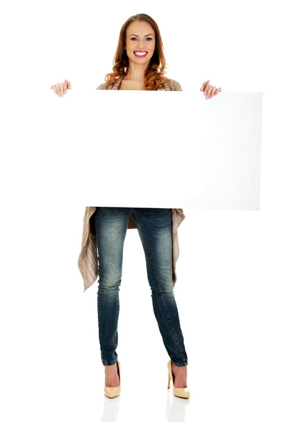 Happy woman with blank board. - Фото, изображение