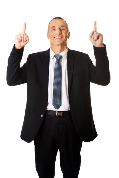Businessman pointing upwards  - Foto, afbeelding
