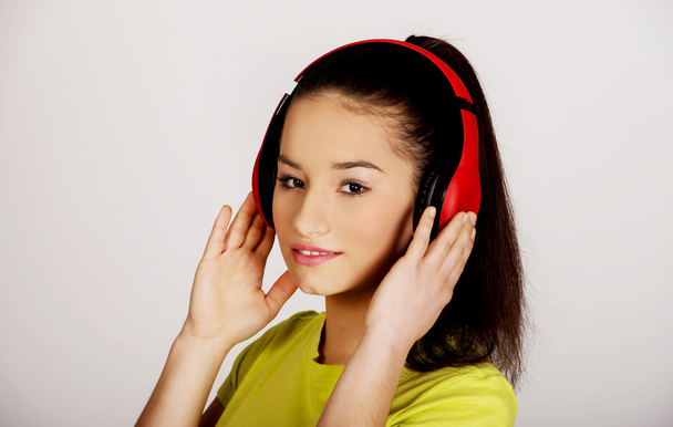 Young woman with headphones listening to music. - Фото, изображение