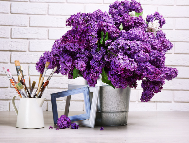 Beautiful lilac flowers in pail on floor - Foto, immagini