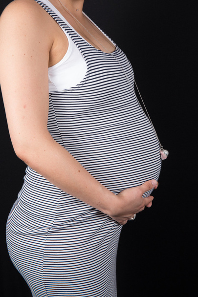 Üçüncü üç aylık dönemde üzerinde siyah izole mutlu hamile bir kadın portresi - Fotoğraf, Görsel