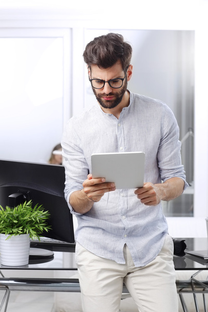Young businessman with digital tablet  - Фото, изображение