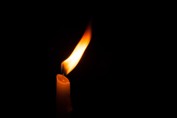 Glowing candles on dark background. - Фото, изображение