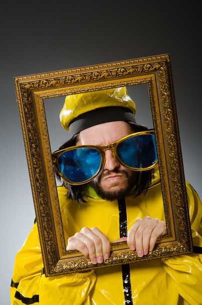 Man wearing yellow suit with picture frame - Photo, Image