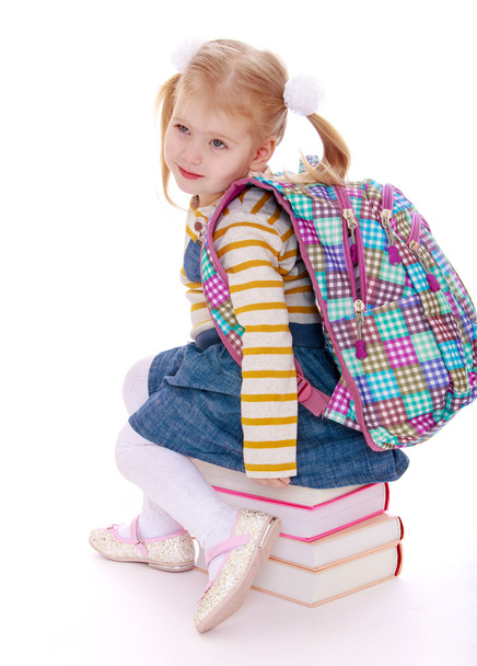  little girl  blonde  with a school knapsack on his back  sittin - Фото, изображение