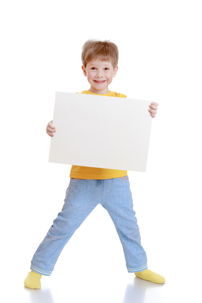 The little boy is holding in front  - Фото, зображення