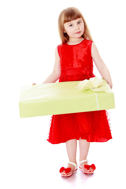 Girl in long red dress holding a large box of beautifully packag - Foto, Imagen