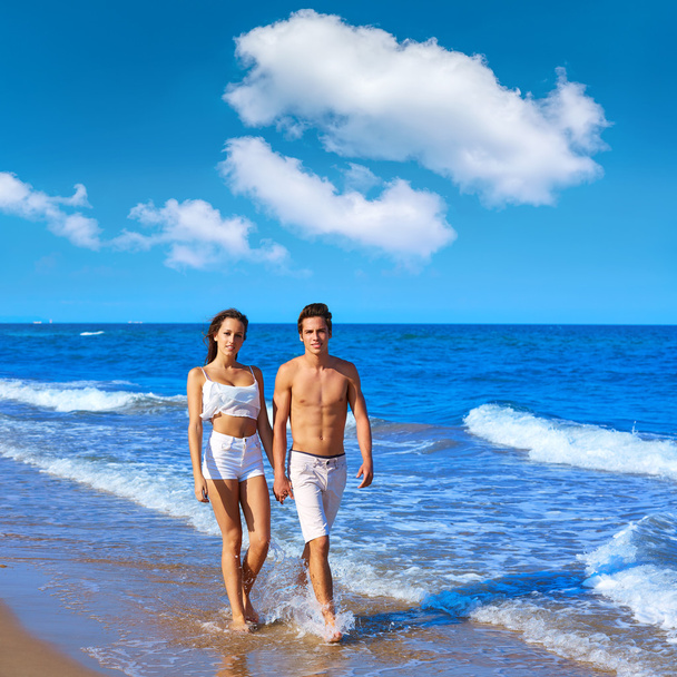 Couple young walking on the beach shore - Photo, Image