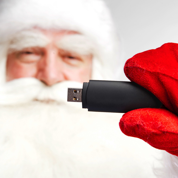 Traditional Santa Claus holding 3g usb modem in his arm on foreg - Foto, Imagem
