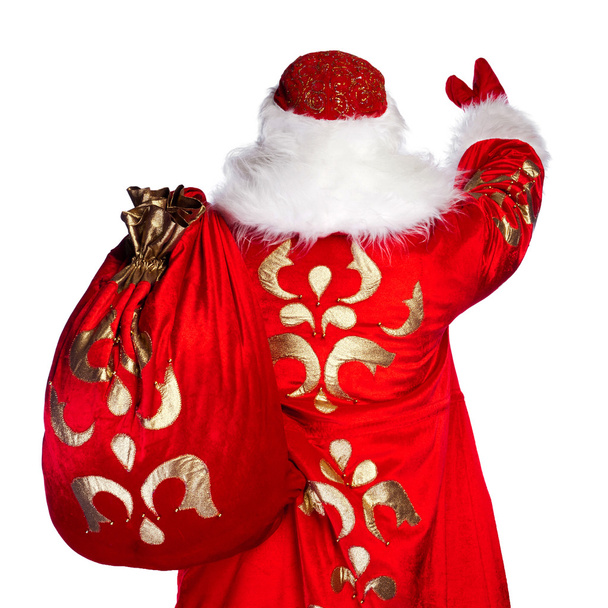 Santa Claus standing up on white background with his bag full of - Zdjęcie, obraz