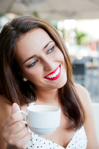 Closeup portrait of a pretty young female having a cup of coffee - Foto, Bild