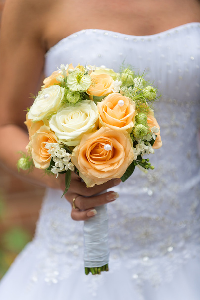 Beautiful wedding bouquet in hands of the bride - Fotó, kép