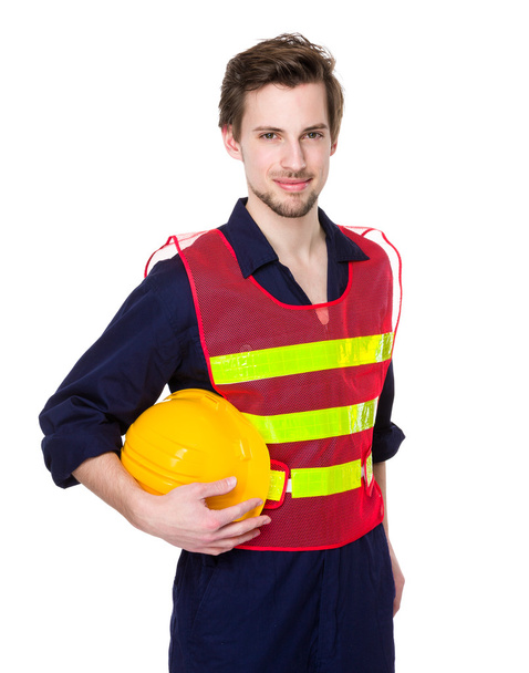 Ingeniero sosteniendo casco protector amarillo
 - Foto, Imagen