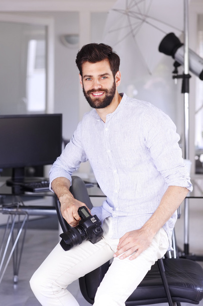 young photographer sitting in studio - Photo, image