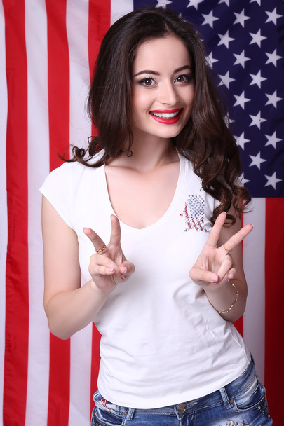 Sexy young woman posing over american flag background - Φωτογραφία, εικόνα