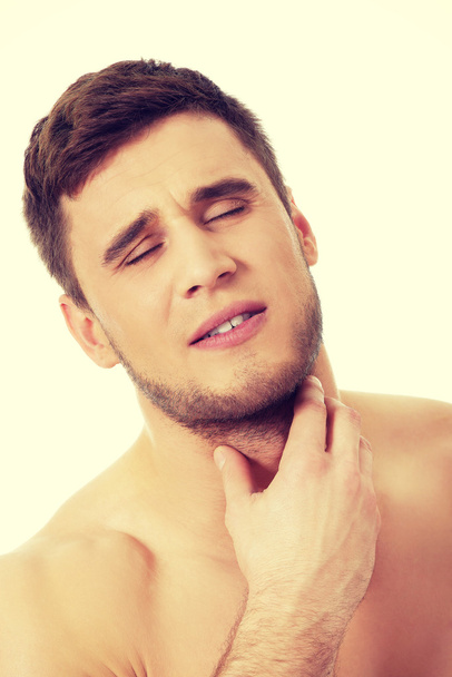 Athletic man feeling pain in his neck. - Photo, Image