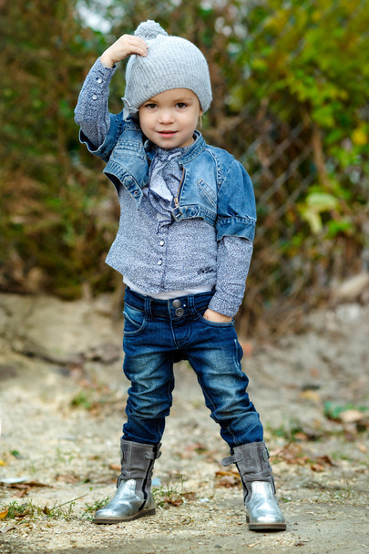 Beautiful Little girl in blue jeans outdoor - Foto, Imagem