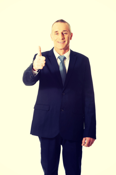 Mature businessman gesturing ok sign - Фото, изображение