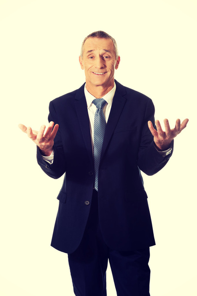 Businessman with open hands in undecided gesture - Foto, Imagem