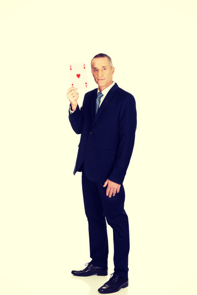 Elegant business man with red ace card - Foto, afbeelding