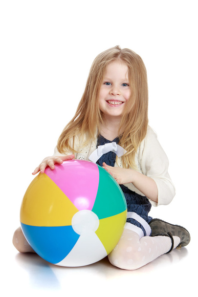 Beautiful long-haired blonde girl with a big ball in his hands - Fotografie, Obrázek
