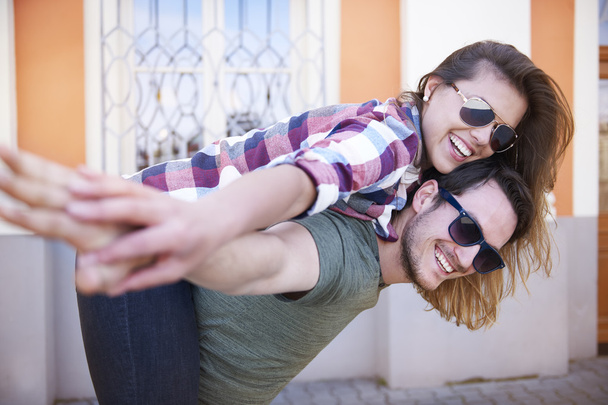 Man giving piggy back to girlfriend - Photo, Image