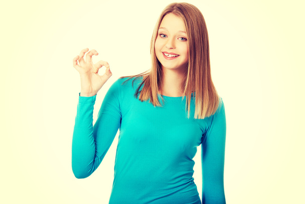 Young woman showing perfect sign - Fotó, kép