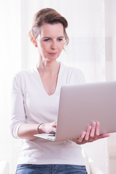 attraktive Frau, die mit dem Computer an ihren Händen arbeitet - Foto, Bild
