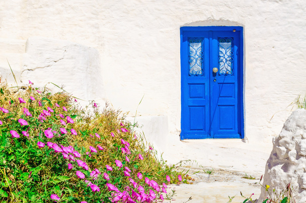 Blue wooden door, white wall and flowers, Greece - Photo, Image