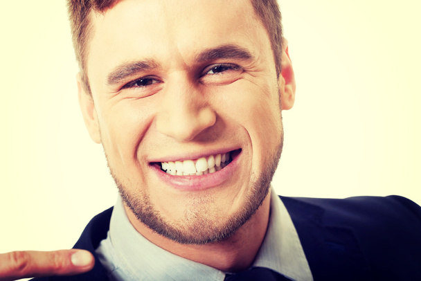 Happy businessman showing his white teeth. - Zdjęcie, obraz