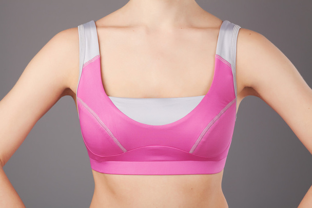 Sporty woman's chest in pink sportswear - Fotó, kép