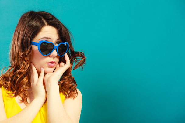 girl wearing blue heart shaped sunglasses - Fotografie, Obrázek
