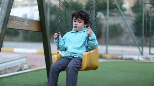 sad little boy on a swing 2 - Footage, Video