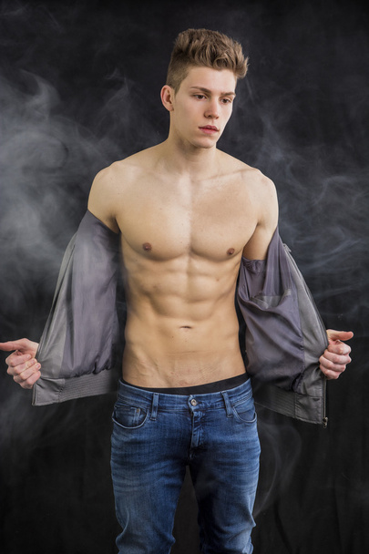 Attractive muscular trendy young man undressing - Fotoğraf, Görsel