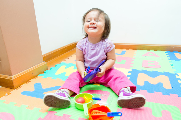 Adorable baby girl playing on floor mats - Valokuva, kuva