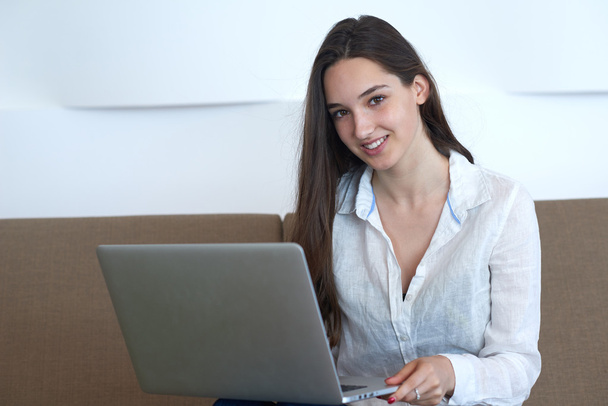 woman relaxing and working on laptop computer - Photo, Image