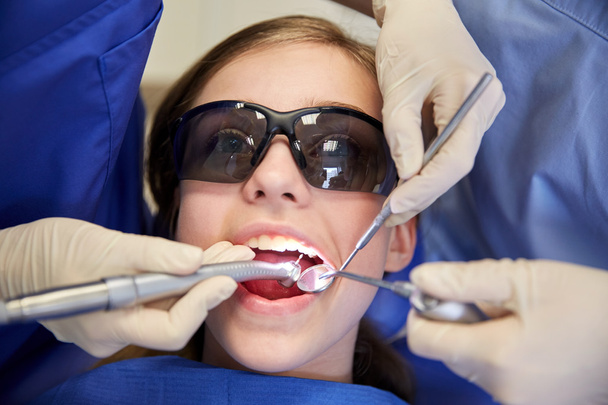 female dentists treating patient girl teeth - Φωτογραφία, εικόνα