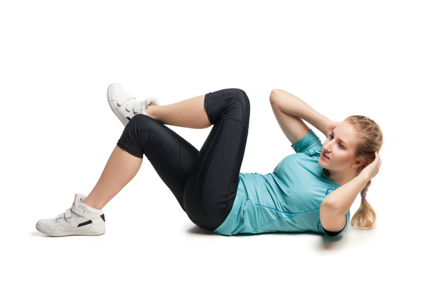 Beautiful sporty woman doing exercise on the floor - Zdjęcie, obraz